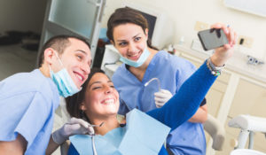 Patient taking selfie with dentist